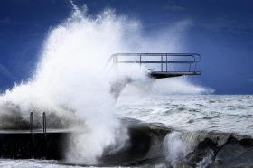 Waves hit a diving board during the Ciara storm on the shore of the Lake Geneva, in Lutry