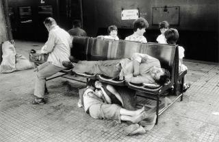 Children sleeping under a bench.