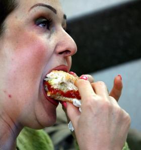 close-up of someone eating a sandwich