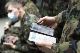 Soldados con mascarillas y teléfonos inteligentes