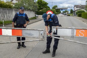 Soldados suíços informam um ciclista que a fronteira com a França perto de Thonex, Genebra, está fechada
