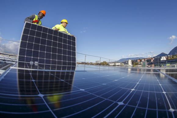men installing solar panel