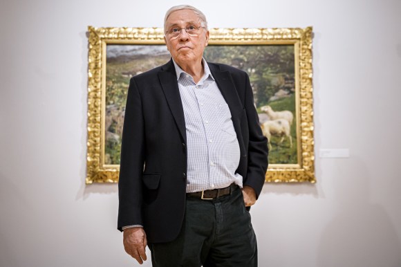 Christoph Blocher stands in front of painting