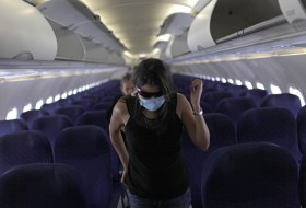 Air passenger with face mask