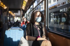 woman with mask in tram