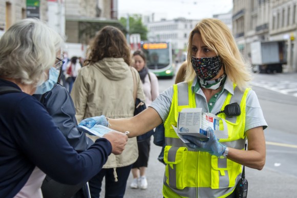 woman handing face mask to passenger