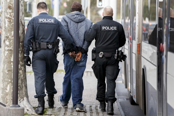 handcuffed man with police