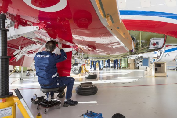 Engineer works on Pilatus plane
