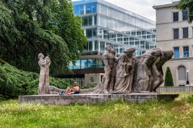 man sunbathes on statue