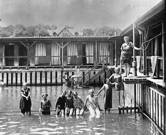 Women standing in water at swimming pool.