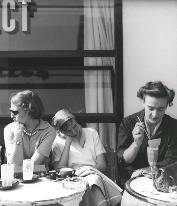 Three women drinking coffee.