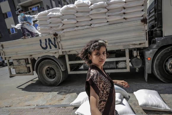 A Palestinian child waits to recieve food supplies with her family in Gaza City.