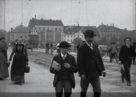 People walking across Basel Bridge in 1896