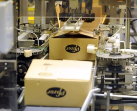 Packaged products on a conveyor belt at a Pfizer factory