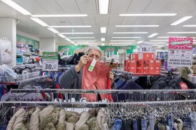An elderly woman shopping for clothing