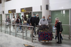 Passengers arrive at an airport