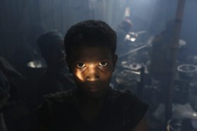 A child worker in Bangladesh poses during a break