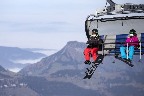 snowboarder and skier on lift