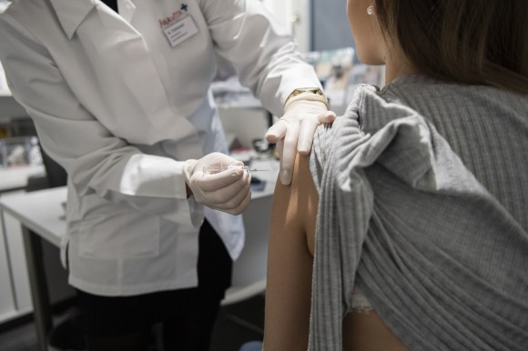 Pharmacist applying a vaccination