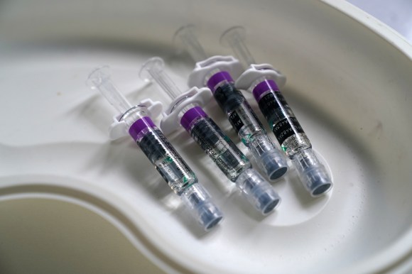 four syringes in a pan