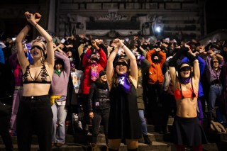 Women demonstrating at night with a flashmob