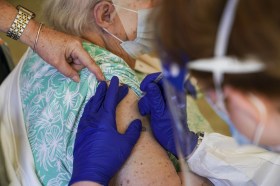 Old woman getting vaccinated