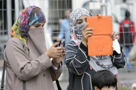Two women wearing face-covering headscarves