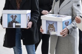 Camapaigners carrying boxes with anti-animal testing petition