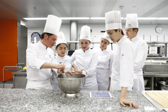 Students in kitchen at Lausanne hotel school