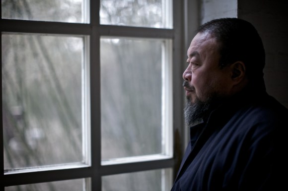 Ai Weiwei looking through a window