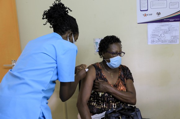 An elderly woman is being administered a Covid-19 vaccine dose in Kenya