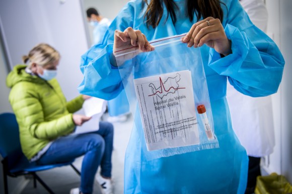 A nurse holding a PCR test