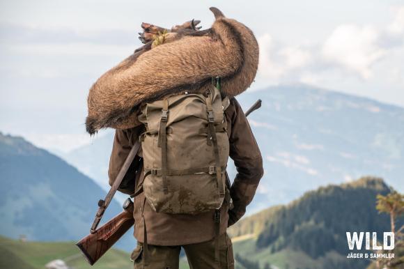 A hunter with a deer on his shoulders
