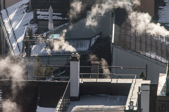 Rooftop with smoking chimneys