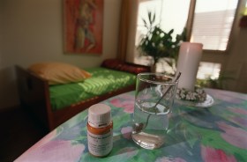 Medication on table by bed