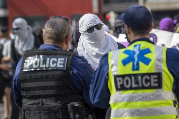 Left-wing demonstrator talks to police