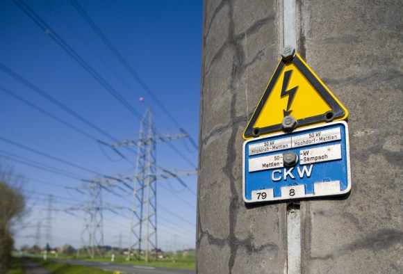 Warning sign by electricity pylons