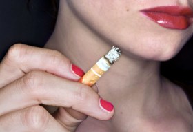 Lower face of a woman holding a cigarette