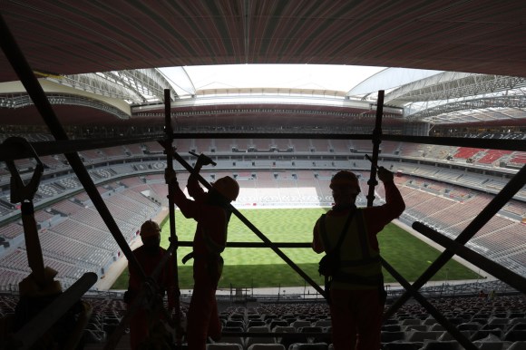 Workers building football stadium