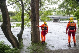 Fire Service Watching As The Flood Water Flows Down A River