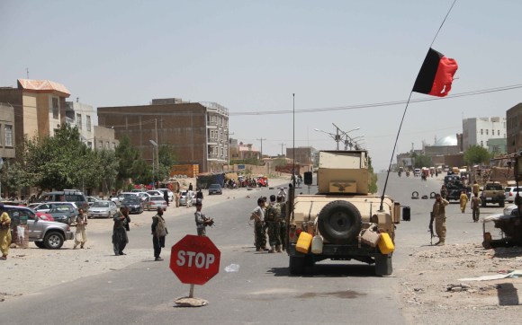 Street scene from Herat city with security officials, militia and a tank