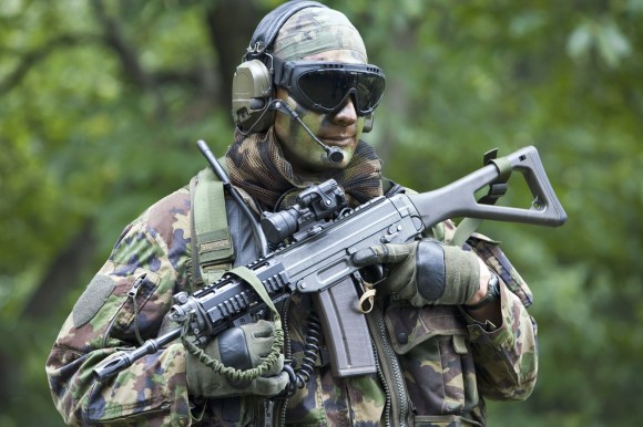 A camouflaged special forces recruit at Isone, canton Ticino.