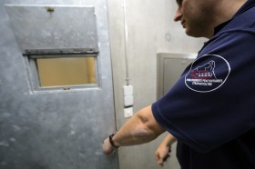 Тюремщик запирает дверь камеры