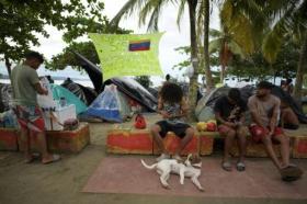 Migrantes venezolanos llegados al puerto colombiano de Necoclí (noroeste) esperan en un campamento la oportunidad para cruzar hacia Panamá y seguir su ruta a Estados Unidos (afp_tickers)