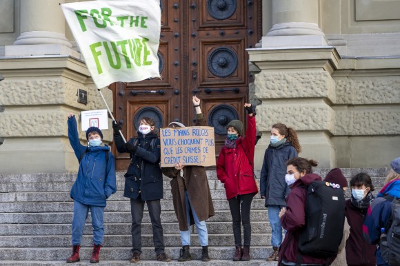 Group of young climate activists posing in front of court building
