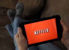 Person watching Netflix on device