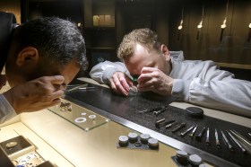 Two men examining watches