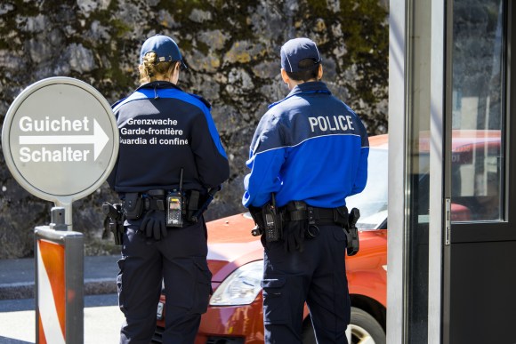 Swiss border police checking cars at the border