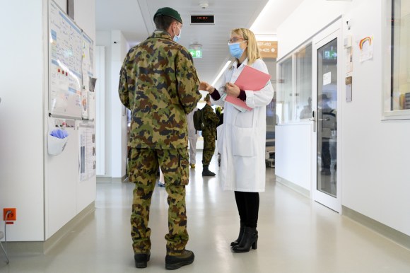 Soldier talks to doctor in a hospital