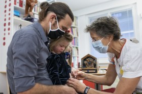 Doctor applying a flu jab to a child